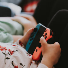 Kid's hands with Nintendo Switch controller